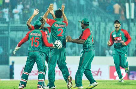Bangladesh cricketer Al-Amin Hossain celebrates with teammates after the dismissal of unseen Indian batsman Shikhar Dhawan during the Twenty 20 match between India and Bangladesh in the Asia Cup T20 cricket tournament at The Sher-e-Bangla National Cricket Stadium in Dhaka on Wednesday.      photo: Observer 