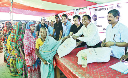 Gaibandha DC Gautam Chandra Pal distributing relief materials to flood-hit people of Kamarjani union in Sadar upazila on Monday.      photo: Observer 