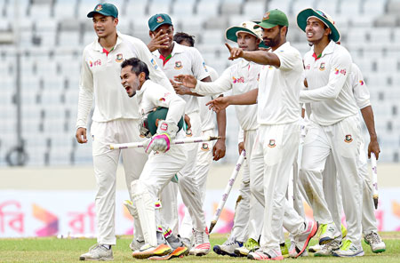 Bangladeshi cricket captain Mushfiqur Rahim (2nd L) celebrate after winning the first Test cricket match between Bangladesh and Australia at the Sher-e-Bangla National Cricket Stadium in Dhaka on Wednesday.    photo: AFP