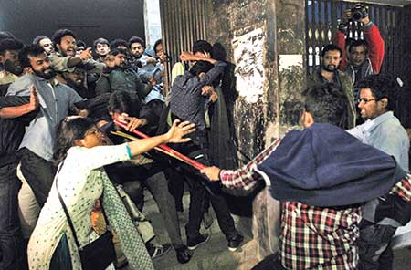The BCL men swoop on demonstrating students who kept Dhaka University Vice Chancellor Prof Akhtaruzzaman confined at his office to press home their demands including punishment of BCL men who harassed some female students earlier. The attack left at least 24 students injured. An injured student (inset) is lying on the ground after he came under attack by BCL men.	photo: Observer 