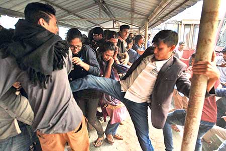The BCL men swoop on demonstrating students who kept Dhaka University Vice Chancellor Prof Akhtaruzzaman confined at his office to press home their demands including punishment of BCL men who harassed some female students earlier. The attack left at least 24 students injured. An injured student (inset) is lying on the ground after he came under attack by BCL men.	photo: Observer 