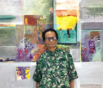 Khurshid Alam Saleem in front of his collage art