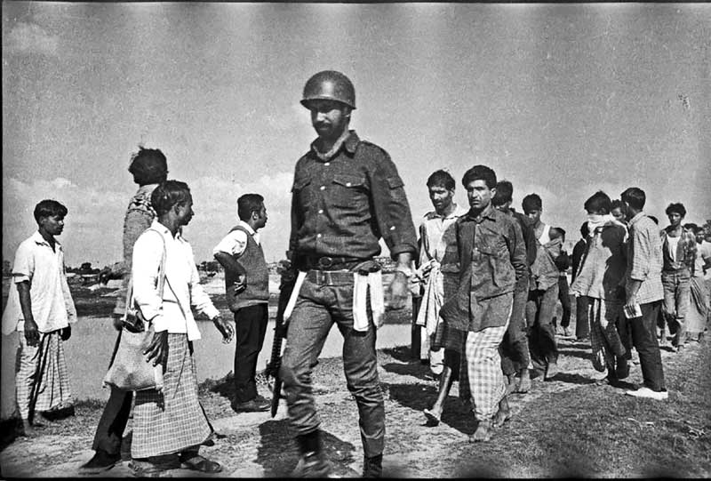 Chief of the Joy Bangla Bahini Kamrul Alam Khan Khasru taking away the collaborators, December 1971