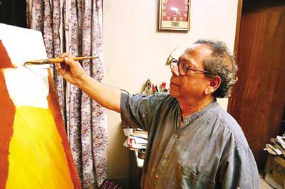 Murtaja Baseer paints on his famed series 