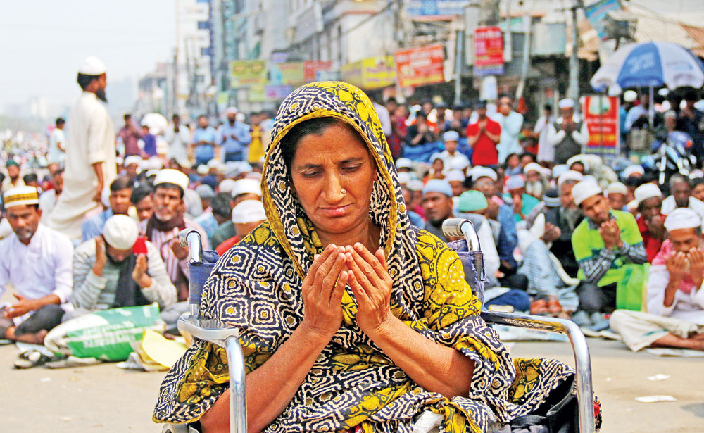 A physically challenged woman with tearful eyes joins the Akheri Munajat of the Biswa Ijtema participated by the  followers of Tabligh Jamaat's Delhi's Markaz on the banks of Turag River in Tongi on Tuesday. 	photo: Observer