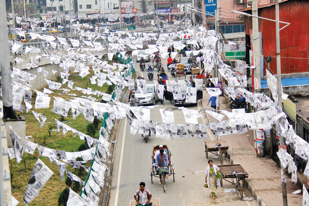 Posters envelop the city streets with the election to Dhaka North City Corporation (DNCC) only a day away. The picture was taken from Merul Badda on Tuesday.	photo: Observer
