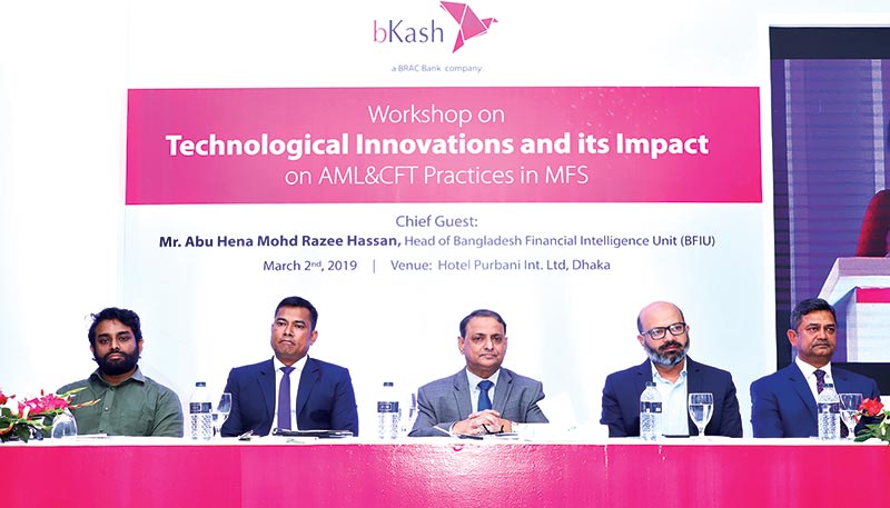 Head of BFIU Abu Hena Mohd. Razee Hassan, flanked by other participants, attend a workshop on 'Technological innovations and its impact on AML&CFT Practices in MFS' as the chief guest at Hotel Purbani International Limited in the capital on Saturday.