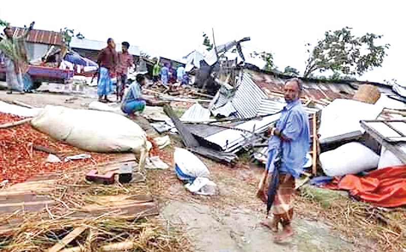 villagers seeing the damaged houses at Mandar Bazaar Village in Rajrajeswar Union of Chandpur Sadar Upazila