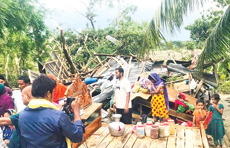 and a damaged house at Koralia Village under Dakkhin Dighaldi Union in Bhola Sadar Upazila