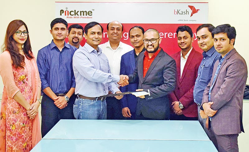 bKash Chief Commercial Officer Mizanur Rashid and Piickme Chief Executive Officer Omar Ali exchanging documents after signing an agreement on behalf of their respective organisations at a ceremony in the capital recently.	photo: Bank