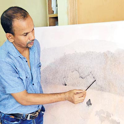 Anukul paints on his canvas