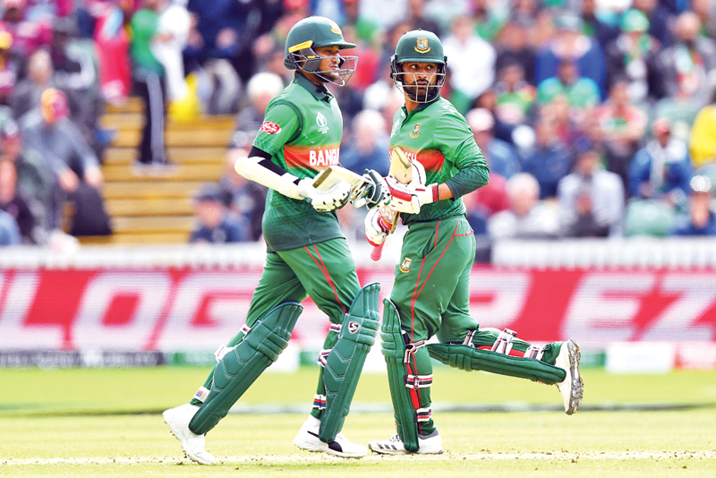 Shakib Al Hasan (R) celebrates his century with Liton Das during the 2019 Cricket World Cup group stage match between West Indies and Bangladesh at The County Ground in Taunton, southwest England, on June 17.	Photo: AFP