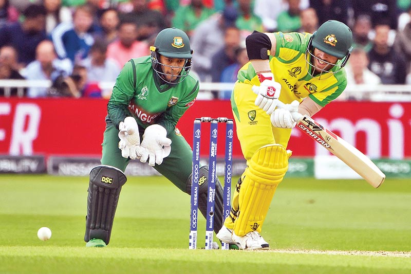 Australia's David Warner plays a shot to reach his century during the 2019 Cricket World Cup group stage match between Australia and Bangladesh at Trent Bridge in Nottingham, central England, on June 20. 	Photo: AFP