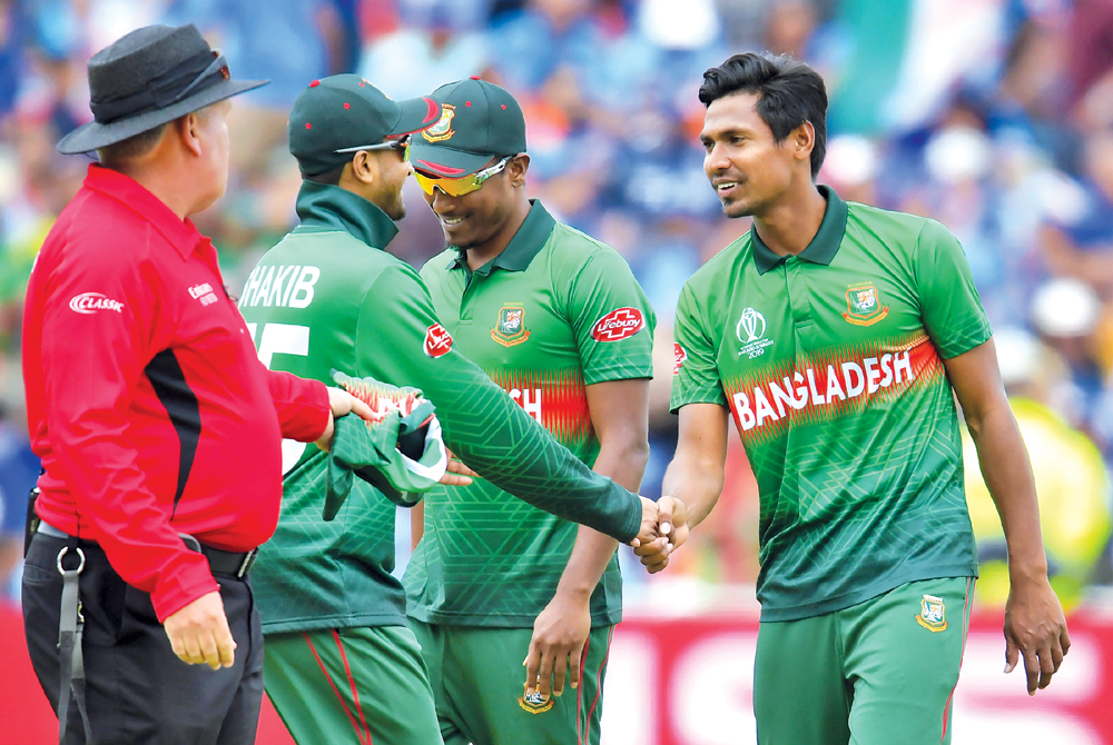 Mustafizur Rahman (R) celebrates with teammates after his five wicket haul in the Indian innings during the 2019 Cricket World Cup group stage match between Bangladesh and India at Edgbaston in Birmingham, central England, on July 2. 	Photo: AFP