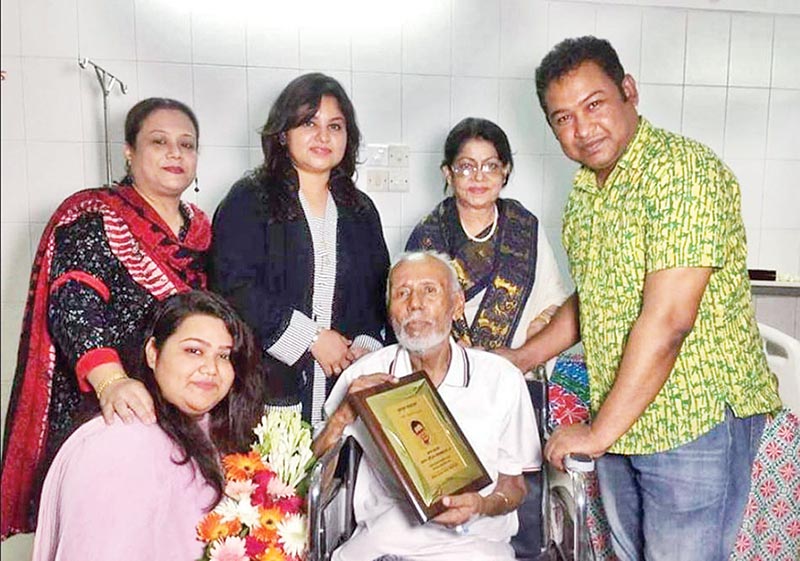 ATM Shamsuzzaman receives the award from the family members of Bulbul Ahmed