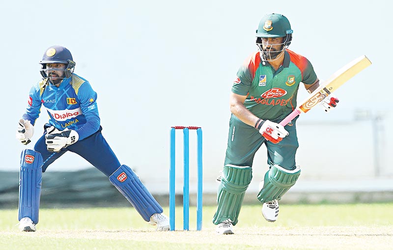 Bangladesh cricket captain Tamim Iqbal (R) runs between the wickets as Sri Lanka Board President's XI Wicketkeeper Niroshan Dickwella (L) looks on during the one-day warm-up match between Sri Lanka Board President's XI and Bangladesh at the P. Sara Oval International cricket stadium in Colombo on July 23, 2019. Veteran Sri Lankan pace bowler Lasith Malinga on July 23 confirmed he will retire from one-day international cricket after the first match against Bangladesh but hopes to play T20 cricket.	photo: AFP 