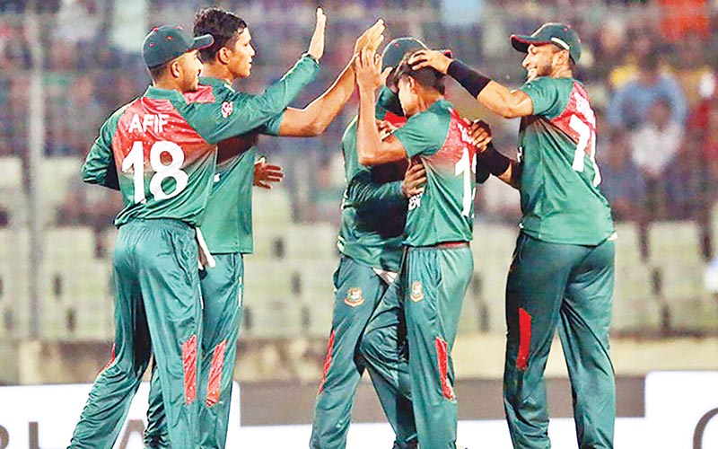 Bangladesh players congratulate Taijul Islam after he claimed a wicket off his first ball in debut match against Zimbabwe in Mirpur on Friday. 	PHOTO: bdnews24.com