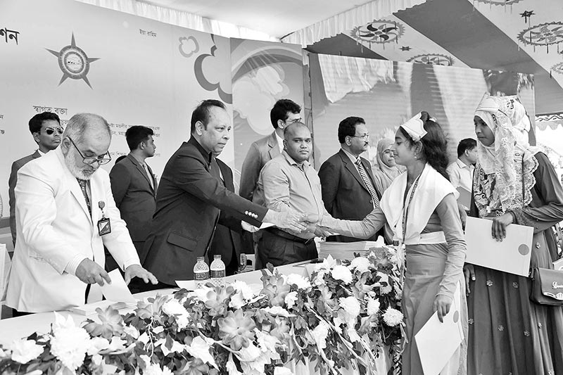 Chairman of KMRF Khwaja Tipu Sultan distributing stipend and honorary certificates to the students at a function at Rajapur High School of Belkuchi Upazila in Sirajganj on Thursday	photo : observer