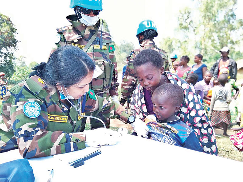 Maj Rezawna Islam, doctor of BANRDB Level One Hospital, taking a physical examination of a malnourished child on Sunday. The Bangladesh Army doctors' team also assists the poor people of the area with their medical needs and arranges medical camps at orphanage and prison cell at Bunia in Democratic Republic of Congo. PHOTO: OBSERVER