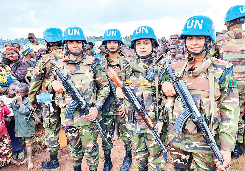 Four members of the Female Engagement Team of the Bangladesh Army in full battle-gear seen engaged in winning the hearts and mind of the Congolese people of the Ituri province in the Democratic Republic of Congo.  	PHOTO: OBSERVER