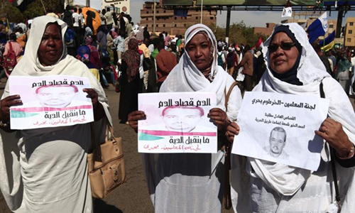 Members of Khartoum's Teachers Association pictured in front the court in Omdurman during the trial on December 30, 2019 of intelligence agents for the death of teacher Ahmed Al-Kheir: AFP