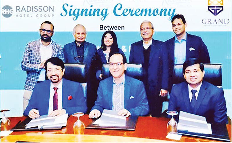Radisson Hotel Group South Asia Chairman and Adviser KB Kachru (middle) and the Grand Hotel Hospitality Ltd Chairman Gazi Mizanur Rahman, Managing Director Gazi Shezan Tanvir and other top officials of both the companies pose at a signing ceremony held in the city recently.