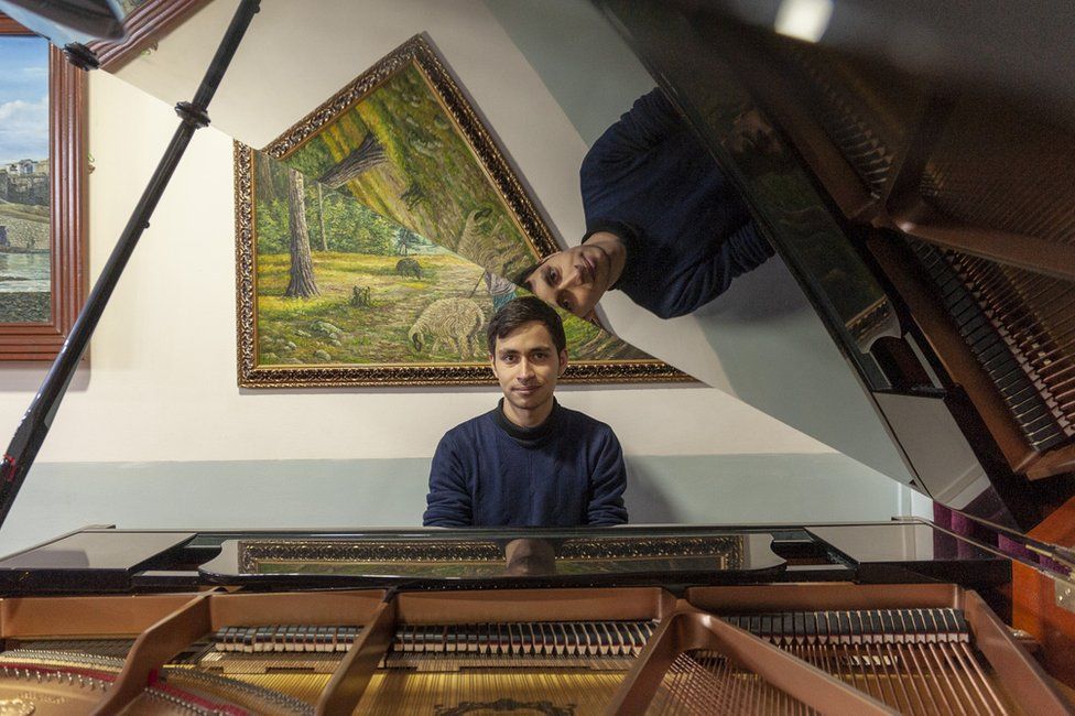 "All those years, I dreamed that one day I could touch a real piano," Fahim said. Photo: BBC