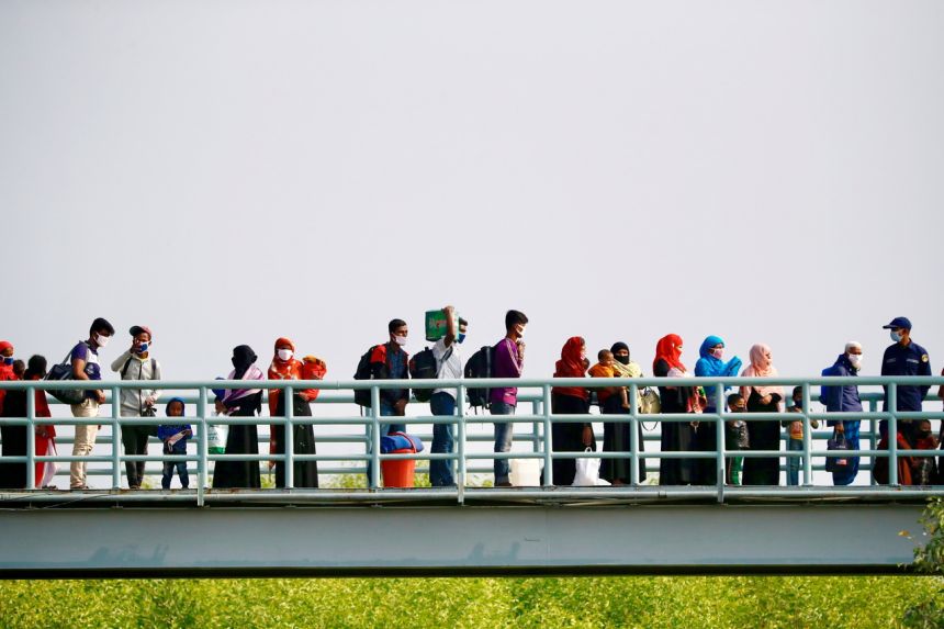 Rohingyas prepare to board a ship as they move to Bhasan Char island near Chattogram, Bangladesh, on Dec 4, 2020.PHOTO: REUTERS