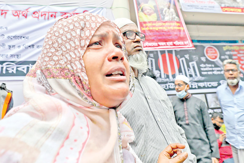 Survivors of the Churihatta chemical warehouse fire gather at the site of the devastation on Sunday on the occasion of two years of the tragedy.  	PHOTO: OBSERVER