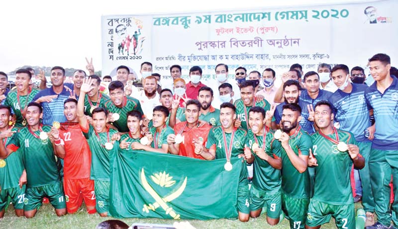 Bangladesh Army football team celebrating after winning gold of the men's football event of Bangabandhu 9th Bangladesh Games on Wednesday at Cumilla District Stadium. 