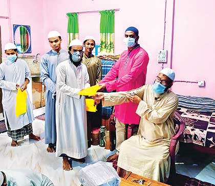 Food assistance was given to the destitute people in Sapahar Upazila on Tuesday (L) and new clothes distributed among orphan madrasa students in Patnitala Upazila of Naogaon on Monday on the occasion of the Eid-ul-Fitr.	photoS: observer