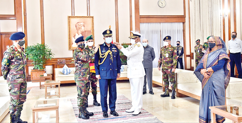 Quarter Master General of Bangladesh Army Lt Gen SM Shafiuddin Ahmed (L) and Assistant Chief of Naval Staff (Operation) Rear Admiral M Abu Asraf adorn  newly appointed Air Force Chief Sheikh Abdul Hannan with the rank badge of Air Marshal in presence of Prime Minister Sheikh Hasina at Ganobhaban on Sunday.	photo : pid	