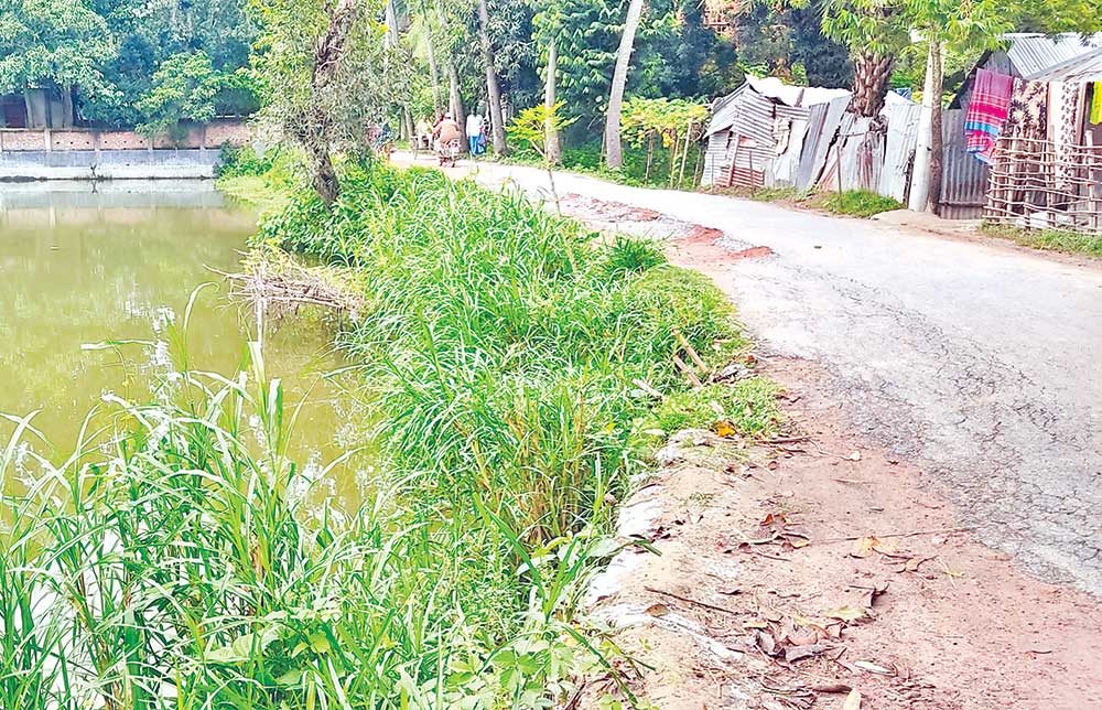 A road in Bagmara Upazila getting damaged due to a side pond.	photo: observer