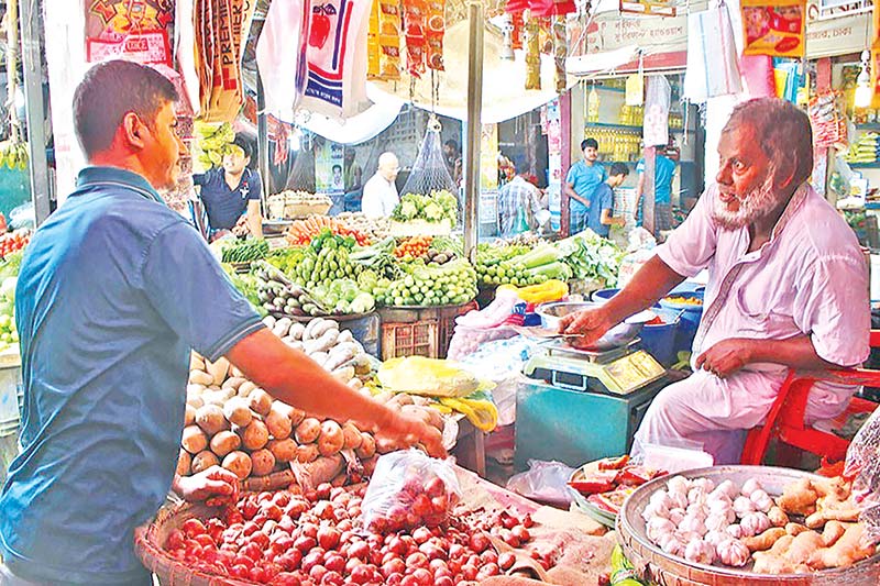 A man buys onions from a shop at the kitchen market in the capital's Karwan Bazar on Wednesday. 	PHOTO: OBSERVER