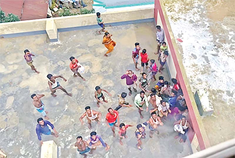 Flood affected people looking up to receive air dropped relief materials from a BAF helicopter in a  remote area of Sunamganj on Wednesday. 	PHOTO: OBSERVER