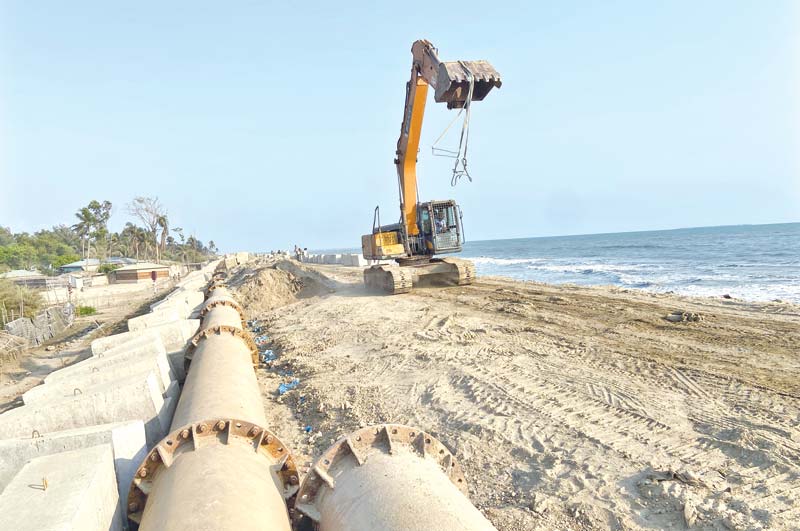 The 6.5-kilometer long dredging pipes, set up on the Shah Pori Island protection embankment as part of the construction of a tourism park is severely damaging the Tk 150 crore embankment through the vibration during sand extraction.	PHOTO: OBSERVER