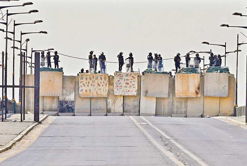 Iraqi security forces block a road leading to the Green Zone in Baghdad
