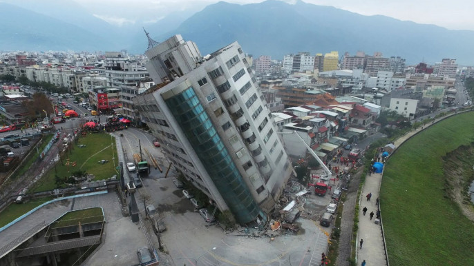 A building teetered Wednesday after its first floor collapsed in an earthquake in Hualien, in Taiwan’s east.