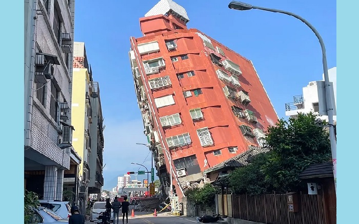 This photo taken by Taiwan’s Central News Agency (CNA) on April 3, 2024 shows people looking at a damaged building in Hualien, after a major earthquake hit Taiwan’s east. (AFP)