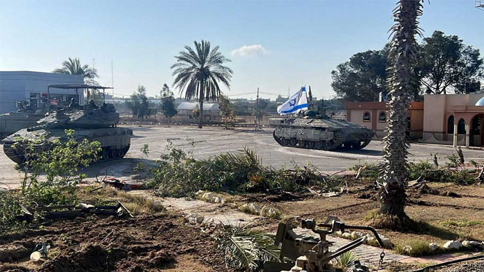 Israeli military vehicles operate in the Gazan side of the Rafah Crossing, amid the ongoing conflict between Israel and Palestinian Islamist group Hamas, in the southern Gaza Strip, in this handout image released on May 7, 2024. REUTERS