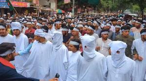 Polytechnic students march wearing funeral shrouds