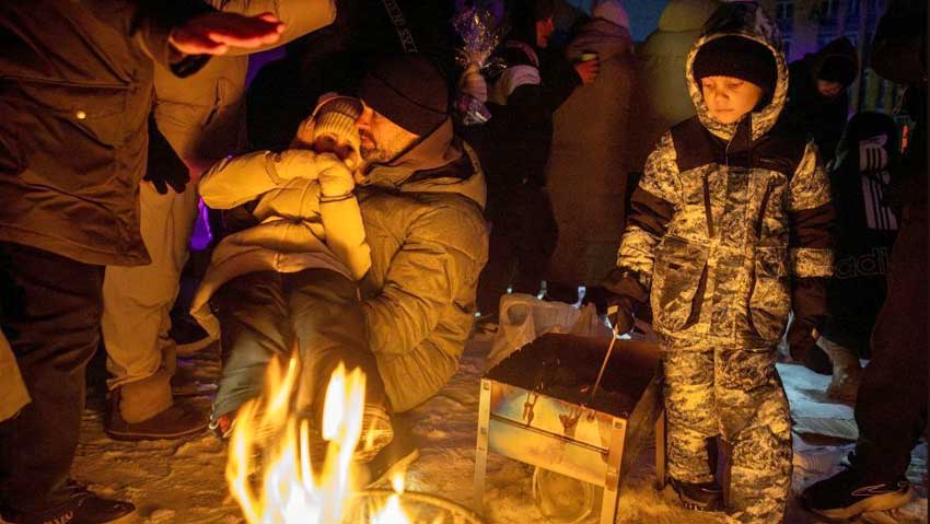 People warm themselves at a bonfire at a party with DJ and food at a sports ground in a neighborhood left without electricity after recent Russian strikes on the capital’s civilian infrastructure, amid Russia's attack on Ukraine, during sub-zero temperatures in Kyiv, Ukraine, 24 January 2026. Photo: REUTERS