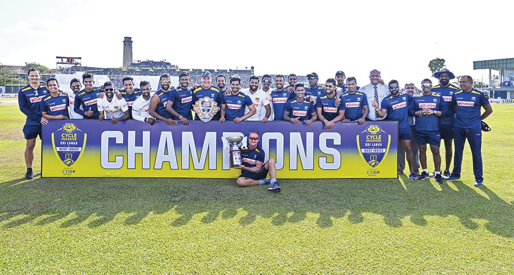 Sri Lanka's team members pose with the trophy as they celebrate their win at the end of the second Test cricket match between Sri Lanka and West Indies at the Galle International Cricket Stadium in Galle on December 3, 2021. 	photo: AFP 