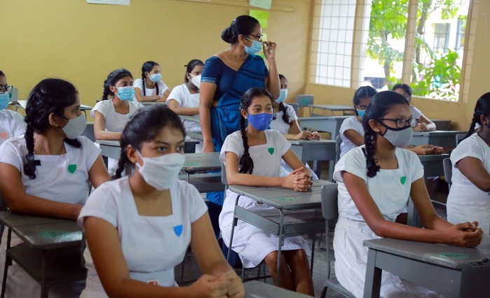 Students wear face masks in a classroom of a school in Colombo, Sri Lanka, on July 6, 2020. (Photo by Ajith Perera/Xinhua)