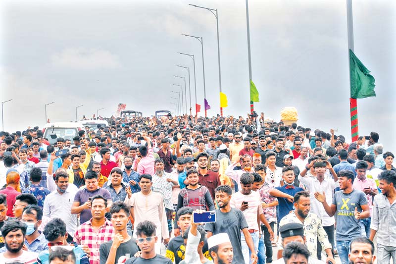 Thousands of people head towards the Padma Bridge soon after it was inaugurated by Prime Minister Sheikh Hasina on Saturday. 	PHOTO: OBSERVER