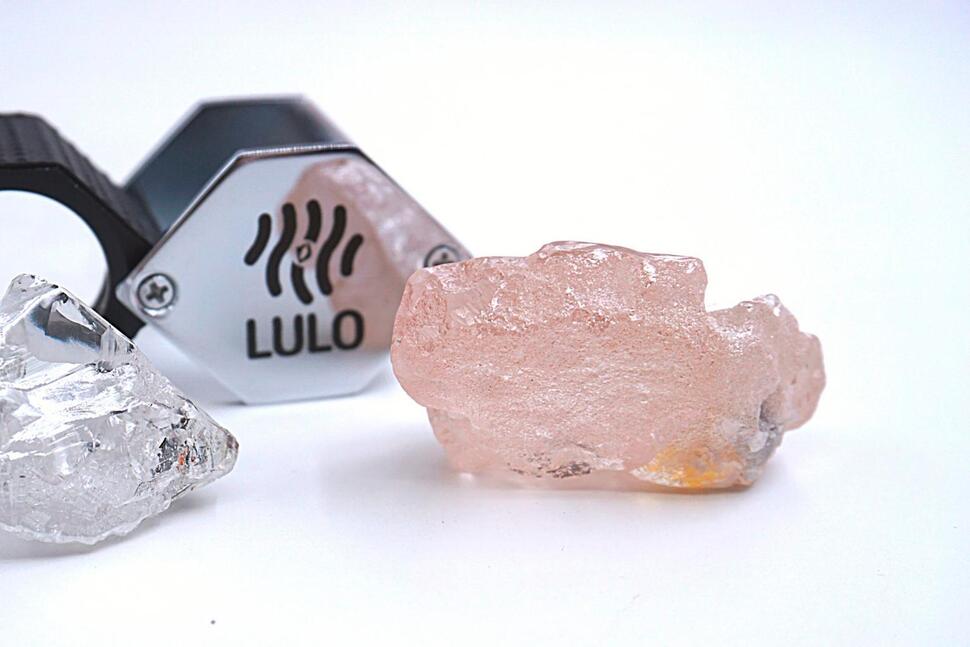 This photo supplied by Lucapa Diamond Company on Wednesday, July 27, 2022, shows the 170 carat pink diamond, right, recovered from Lulo, Angola. A big pink diamond of 170 carats has been discovered in Angola and is claimed to be the largest such gemstone found in 300 years. Called the “Lulo Rose,” the diamond was found at the Lulo alluvial diamond mine. The mine’s owner, the Lucapa Diamond Company, on Wednesday announced the discovery of the large pink diamond on its website. (Lucapa Diamond Company via AP) 