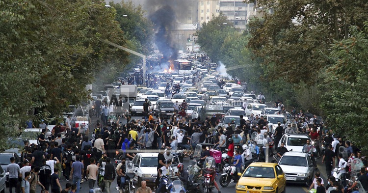 In this Wednesday, Sept. 21, 2022, protesters chant slogans during a protest over the death of a woman who was detained by the morality police, in downtown Tehran, Iran. 