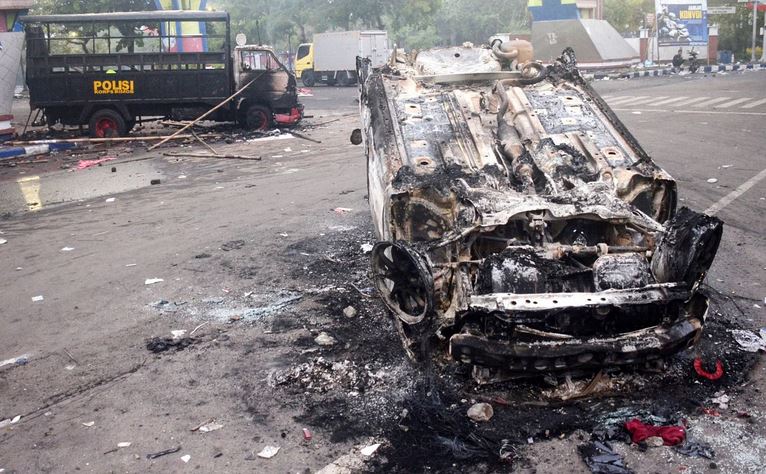 Torched vehicles seen outside Kanjuruhan Stadium. PHOTO: AFP