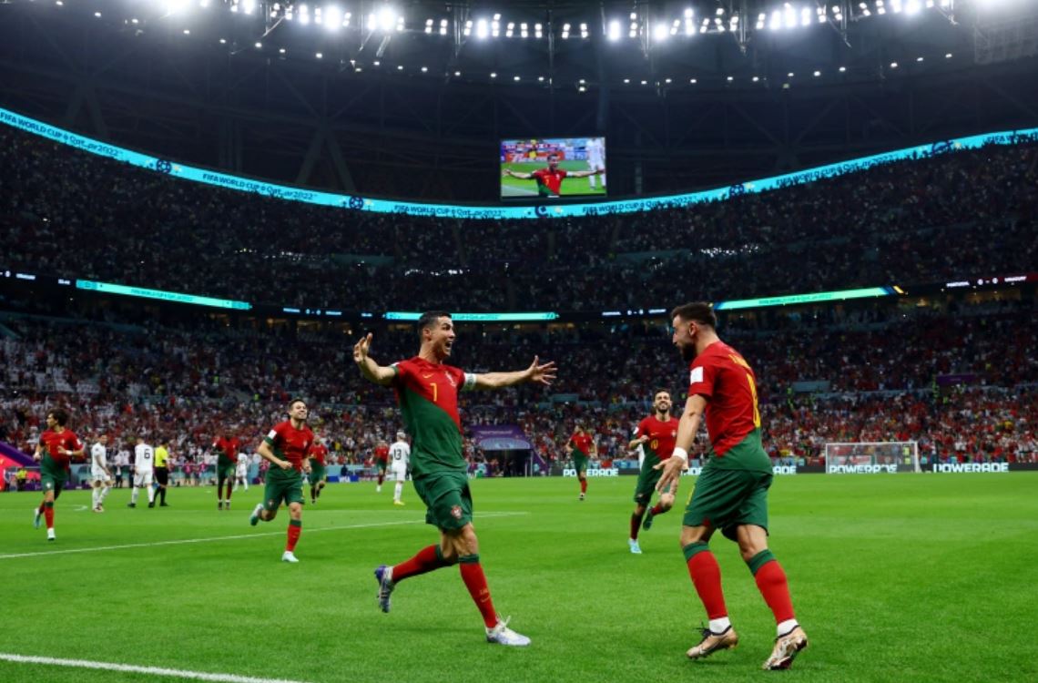 Ronaldo, left, and Fernades celebrate Portugal's first goal [Lee Smith/Reuters]