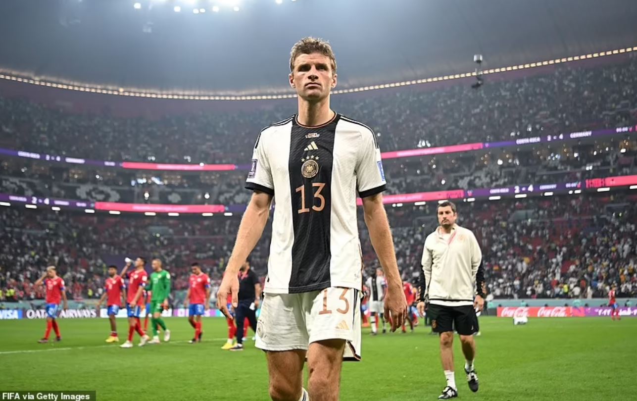 Japan's victory over Spain meant Germany were dumped out of the tournament as a dejected Thomas Muller looks on